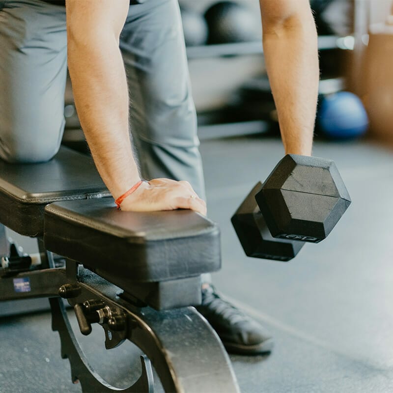 Hybrid Fitness Academy man lifting weights close-up