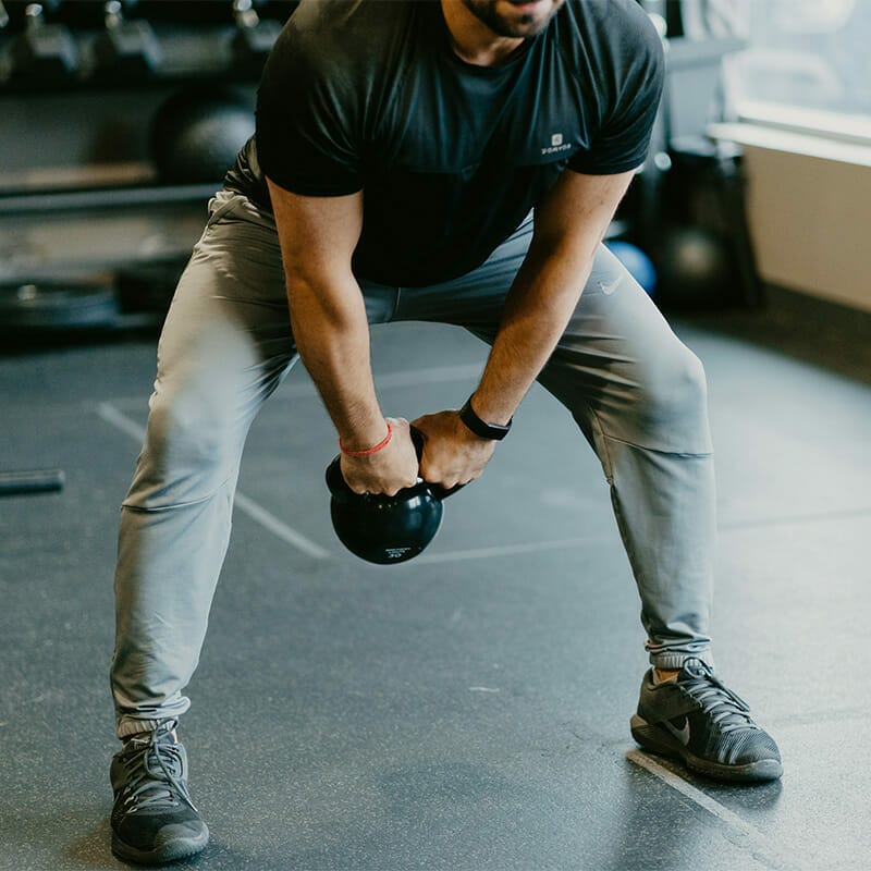 Man exercising with a dumbbell at Hybrid Fitness Academy